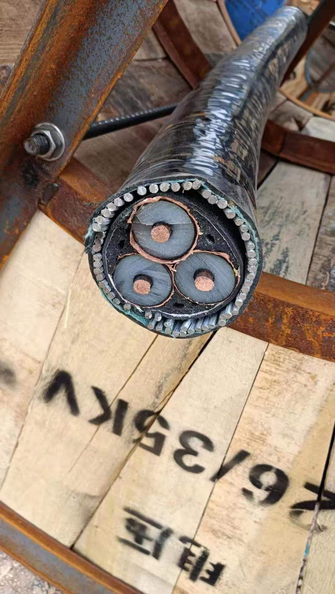 3-core medium-voltage XLPE cable cross-section on cable drum — same physical construction serves IEC, BS, and SANS standards when documentation is correct