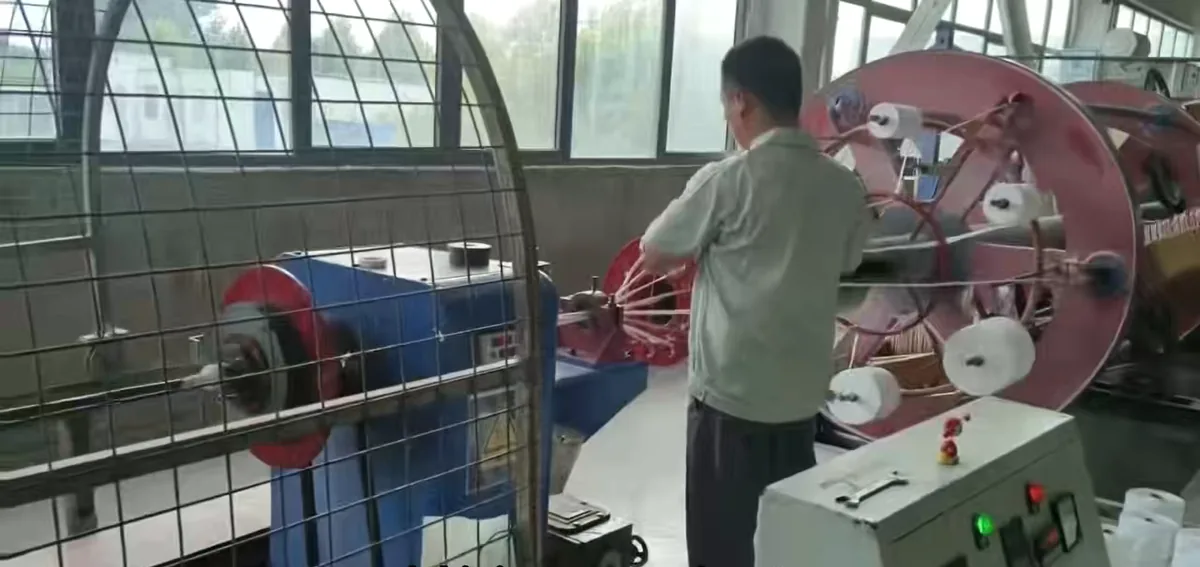 Steel wire armouring machine applying galvanized wire armour to XLPE power cable in a Chinese cable factory