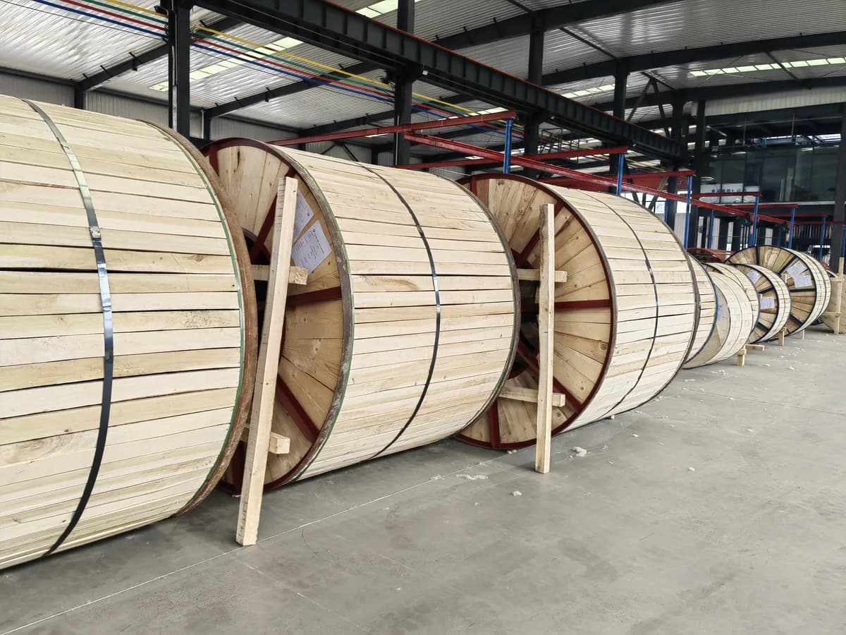 Drums of steel wire armoured cable being loaded into a shipping container for export