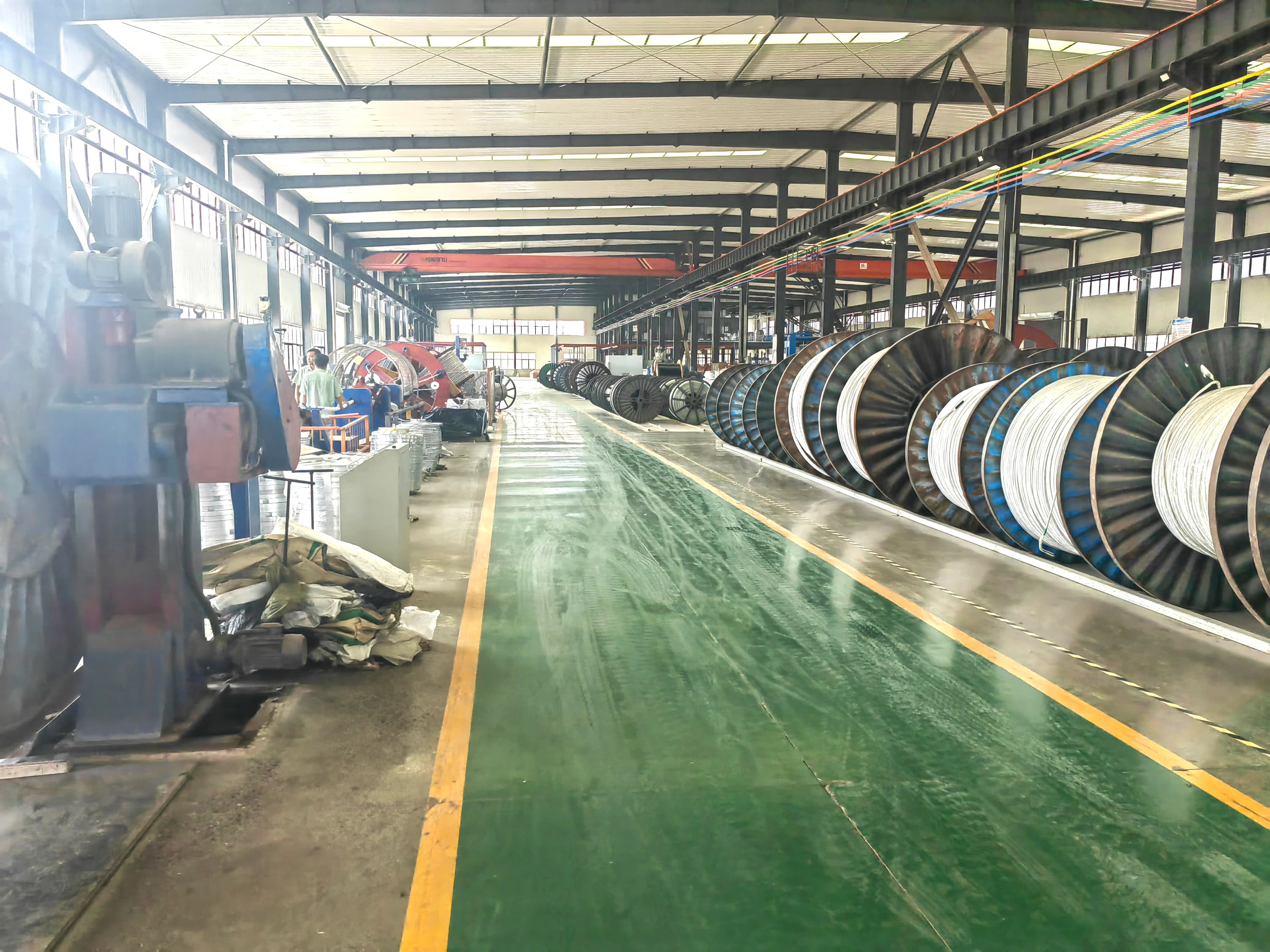 Cable manufacturing facility with production lines and cable drums — multi-standard export production capability